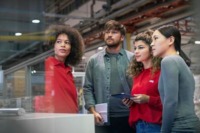 4 ABB colleagues in factory environment
