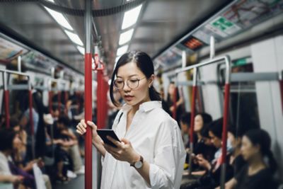 Woman on a train using her phone