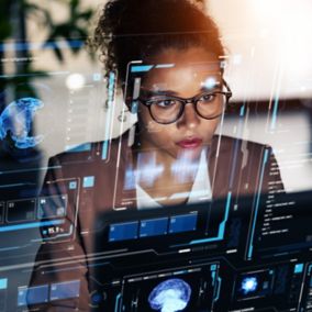 Woman working in office and futuristic graphical user interface concept. ICT (Information Communication Technology). System engineering.