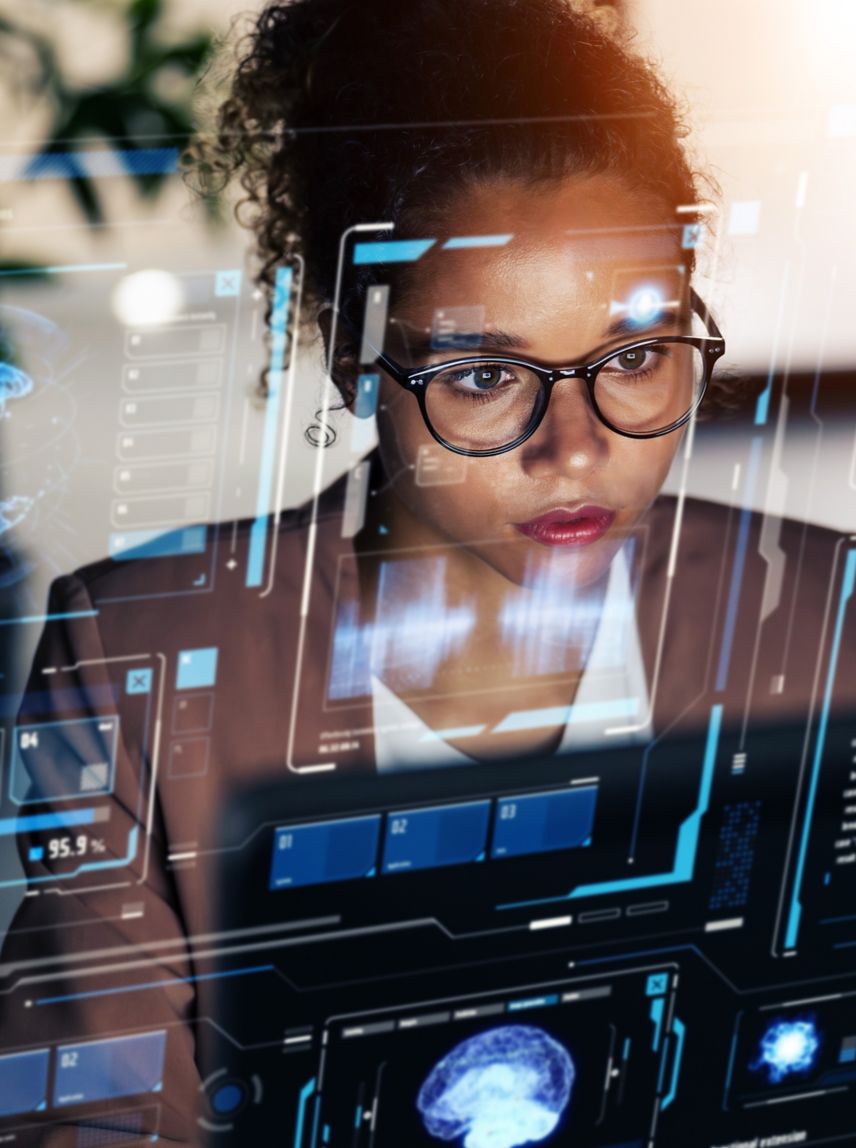 Woman working in office and futuristic graphical user interface concept. ICT (Information Communication Technology). System engineering.