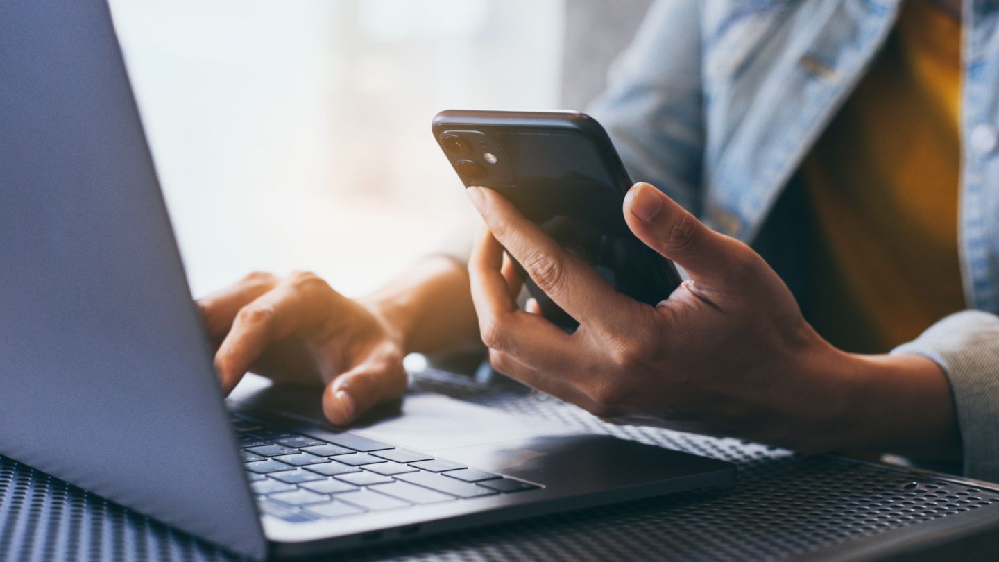 work using texting cell phone typing computer.chatting on mobile,laptop contact us at workplace Thinking investment plan Investor.searching information internet.connecting people concept